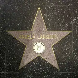A five-point star set in the ground; the name "Angela Lansbury" is written in the centre of it in gold lettering