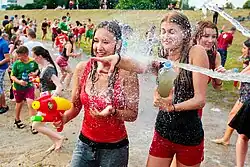 People throwing water over each other