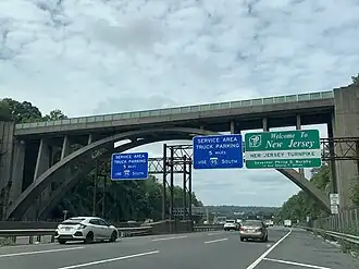 Sign welcoming drivers to the New Jersey Turnpike under the Edgewood Road Bridge in Leonia, New Jersey