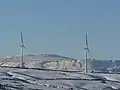 Two of the Hameldon Hill Wind Farm turbines in the winter of 2008.