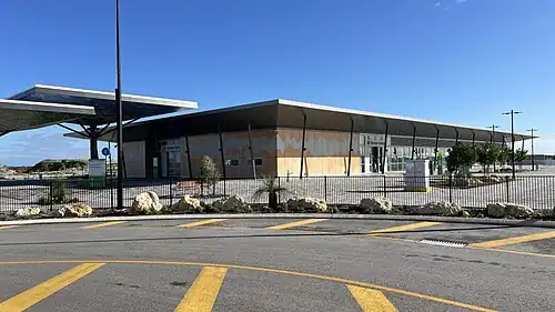 Rectangular shaped building in front of a tiled forecourt