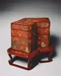 Japanese tiered food Box with stand; late 18th century; red lacquer over a wood core, with litharge painting and engraved gold designs; overall: 53 x 68 cm; Cleveland Museum of Art