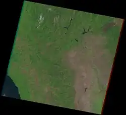 A 1992 satellite image shows a dark brown scar surrounded by forests just after the fire